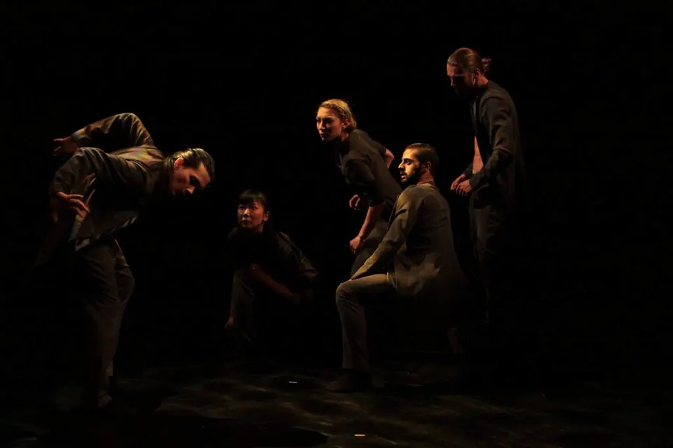Five dancers folding and turning together in Origami for BallettPforzheim